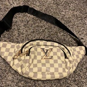 cream and brown Louis Vuitton fanny pack